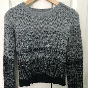 Delia’s black and gray sweater